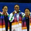 The winner of first Gold medal of the 19th Commonwealth Games, Nigeria's Augustina Nkem (center) with India's  Siver medal winner Sonia Chanu (left)  and Bronze medal winner Sandhya Rani devi(Right) at the 48-kg category womens weightlifting