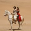 Abhishek and Priyanka sitting on a horse