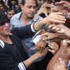 Fans crowd around Shahrukh Khan as he arrives at Big Cinemas