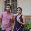 Chetan Bhagat and his wife pose with inked fingures