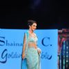 Tara Sharma walks the ramp at the 'Caring with Style' fashion show at NSCI