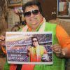 Bappi Lahiri shows the poster of 'Life of Football', his Latest single