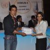 Sonu Sood giving certificate to student at MUNA event.