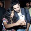 Varun poses for a selfie with a young fan
