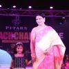 A guest with a child walk the ramp at the Teach for Change 2014 Fashion Show