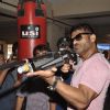 Suniel Shetty plays a shooting game at the Promotions of Desi Kattey