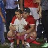 Aamir khan holds a kid at Charity Football Match