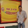 Ajay Devgn poses for the media at Radio Mirchi Studio