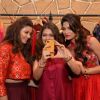 Parvathy Omanakuttan and Daisy Shah pose for a selfie with a fan