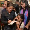 Mary Kom signs an autograph for a young fan at The Hab promoted by Usha International