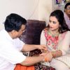 A pandit ties a sacred thread to Rani Mukherjee at Ambaji Temple