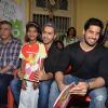 Varun Dhawan and Sidharth Malhotra pose with a kid at Ashray Ngo