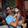 Suniel Shetty poses with a small kid at Araish Charity Exhibition