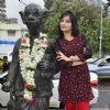 Aditi Sharma with the comman man's statue of R.K. Laxman
