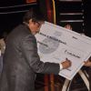 Amitabh Bachchan signing the Seven Crore Cheque