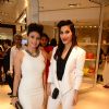 Sophie Choudry and Tanishaa Mukerji pose for the media at Michael Korrs Store Launch