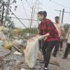 Tammanah cleans the garbage at a Cleanliness Drive