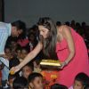 Sonalee Kulkarni distributes sweets amongst the children at the NGO