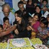 Children feed cake to Aishwarya Rai Bachchan at Smile Train Organisation