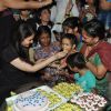 Aishwarya Rai Bachchan feed cake to Children at Smile Train Organisation