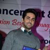 Ayushmann Khurrana poses with a book at Fertility Conference