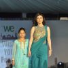 Ragini Khanna walks the ramp with a small girl at Wellingkar's 26/11 Tribute