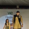 Sangram Singh walks the ramp with a small girl at Wellingkar's 26/11 Tribute
