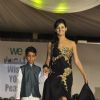 Shakti Mohan walks the ramp with a small boy at Wellingkar's 26/11 Tribute
