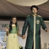 Barun Sobti walks the ramp with a small girl at Wellingkar's 26/11 Tribute