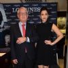 Aishwarya Rai Bachchan poses with an official at the Launch of Longines Store