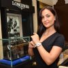 Elli Avram showcases a watch at the Watches of the World Showroom