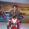 Ali Fazal poses on a bike at Autocar Show