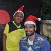 Ali Fazal poses with a Ngo Kid at the Christmas Celebrations