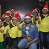 Ali Fazal poses for the media with Ngo Kids at the Christmas Celebrations