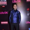 Varun Dhawan poses for the media at 21st Annual Life OK Screen Awards Red Carpet