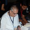 Gulzar was snapped signing autograph at the Launch of Gulzar Pluto Poems Book