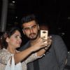 Arjun Kapoor gets snapped with a fan at the airport