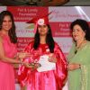 Lara Dutta giving scholarship to the winner at Fair & Lovely Foundation Event