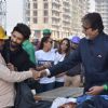 Big B Donates Clothes to workers at construction site!