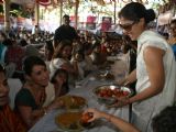 Kajol serves food to Rani Mukherjee at a Durga Pooja pandal in Mumbai