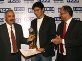 FICCI Sec Gen Dr Amit Mitra and Atul Singh presenting sports awards to Vijender Singh in New Delhi