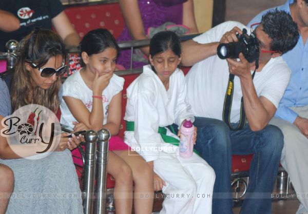 Shahrukh Khan takes photo of wife Gauri Khan while daughter Suhana looks on during the 6th National Taekwondo Competition 2010 Juniors & Sub Juniors