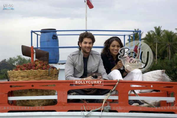 Neil and Bipasha sitting on a truck (11208)