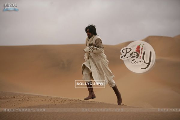 Abhishek walking alone on a sand