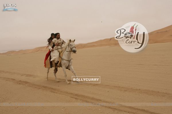 Abhishek and Priyanka running in a horse