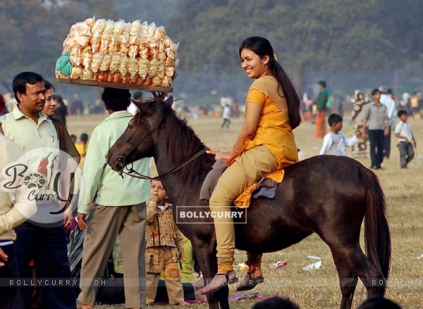 A lady tourist enjoys horse ride during the first day of New Year 2011 in Kolkata Maidan on Saturday. .