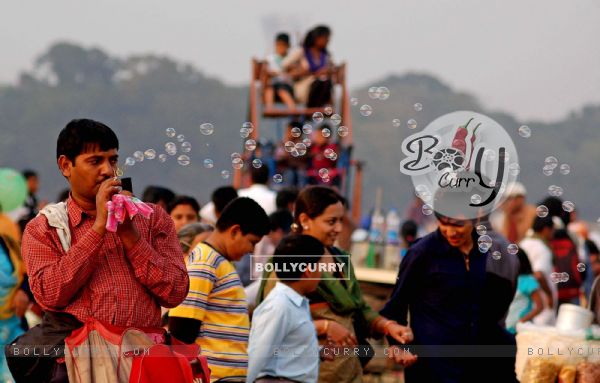 A hawker trades while tourists enjoy first day of New Year 2011 in Kolkata Maidan on Saturday. .