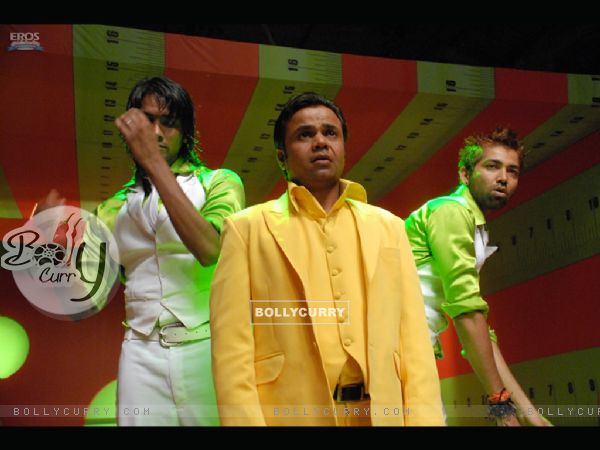 Rajpal Yadav wearing a yellow suit