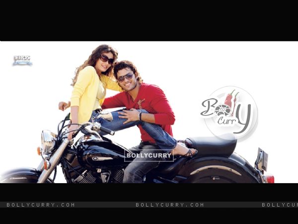 Kumar Saahil and Sneha Ullal sitting on a bike (12075)