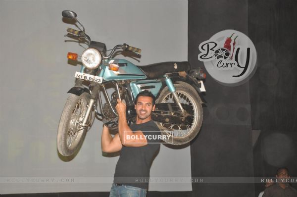 John Abraham holds up bike during the promotion of their film 'Force' in Mumbai (161275)